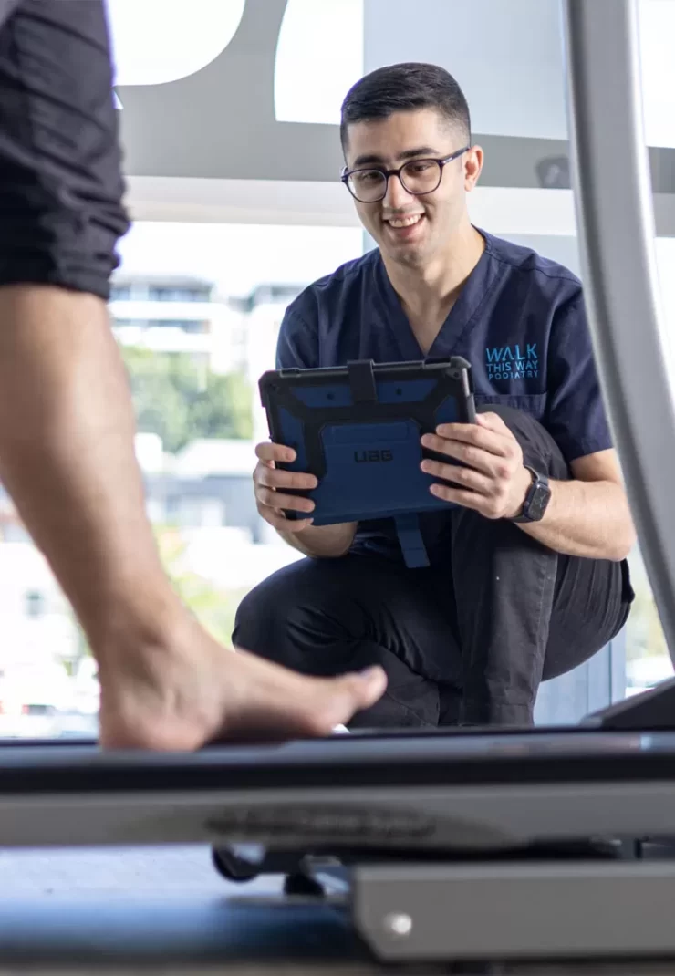 Podiatrist performing gait analysis for orthotics prescription